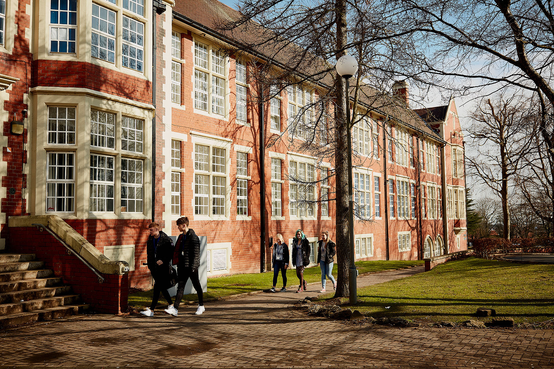 A group of students walking towards Sunderland College Bede Campus.