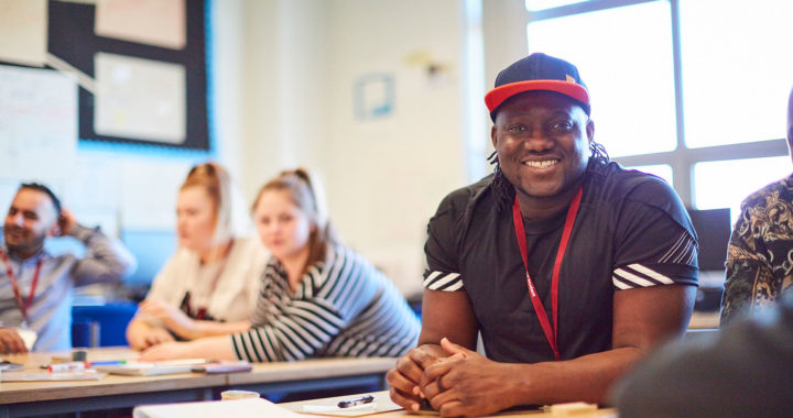 An adult business student smiling at the camera at Sunderland College