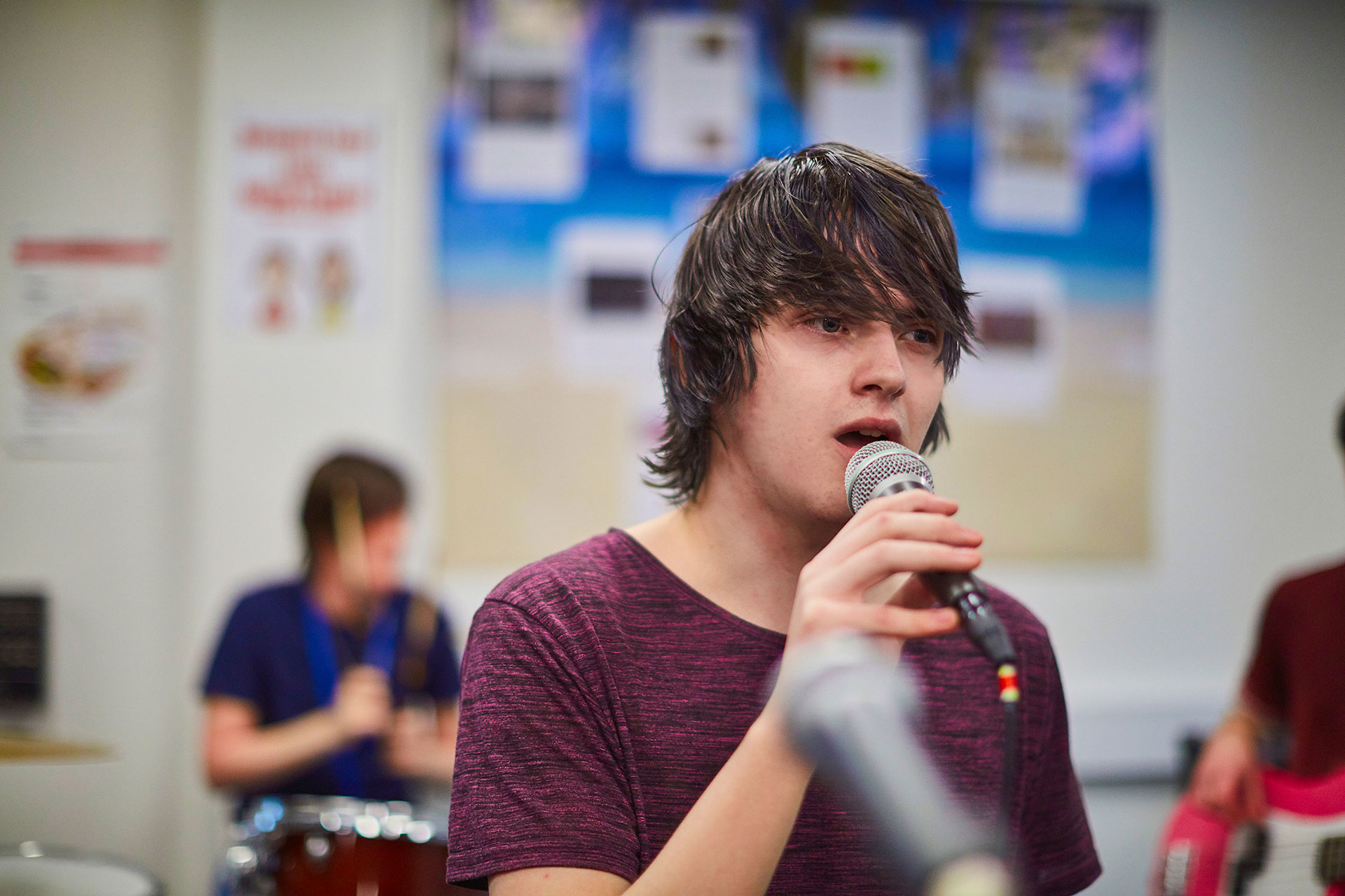 A Music student singing into a microphone at Sunderland College