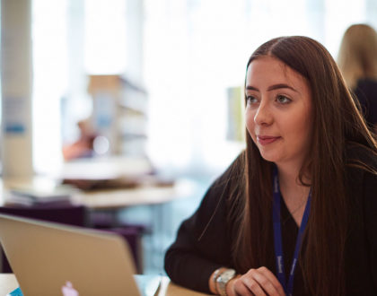 A student at Sunderland College working at a laptop