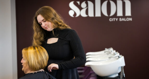 A Student at Sunderland College City Campus, styling the hair of someone
