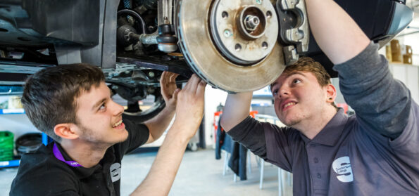 Students carrying out work on electric cars.