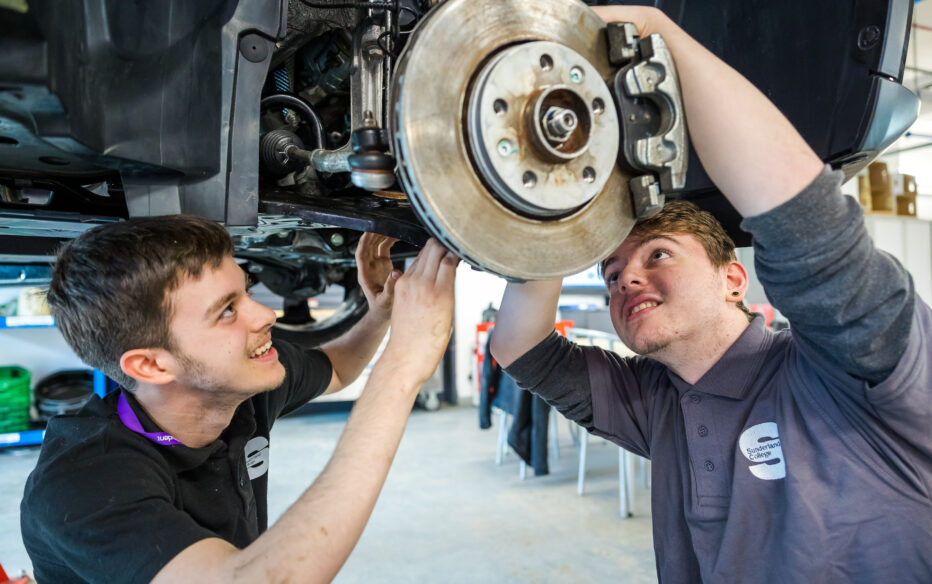 Students carrying out work on electric cars.