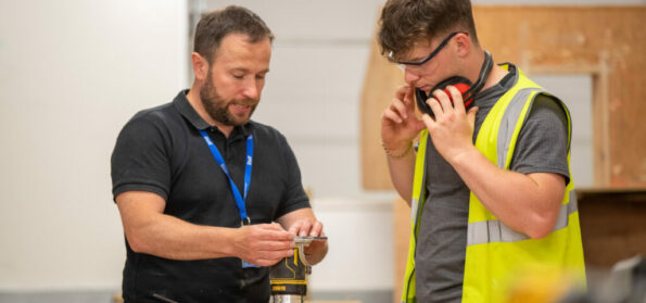 A Sunderland College Construction student in wokrshop with teacher.