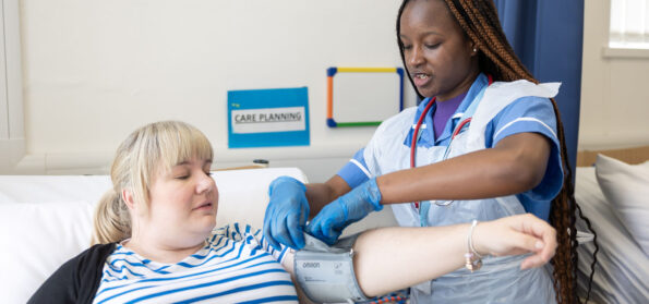 A nursing student performing an examination on a patient.