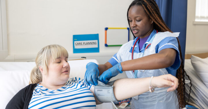 A nursing student performing an examination on a patient.