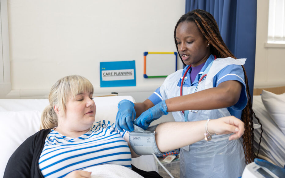 A nursing student performing an examination on a patient.